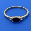 Ovális 4 karomba foglalt fekete, fehér cirkon kővel díszített arany gyűrű
