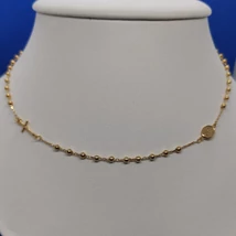 Anker szemekből készült arany lánc, amelyben apró golyócskák vannak + díszítésként csodás érem, és egy kereszt medál van beépítve. Aranylánc + olvasó