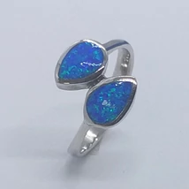 Eltolt fejrésszel készített, végein csepp alakú, kék opál kövekkel készített ezüst gyűrű