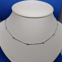 Kocka szemekből összeállított hosszúkás golyókkal díszített ezüst lánc